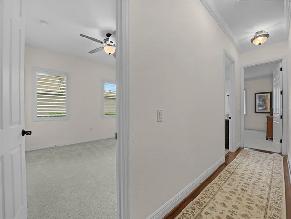 a bedroom with a bed rug and wooden floor