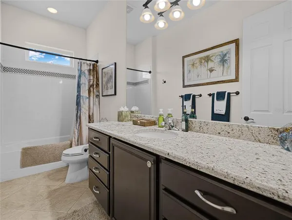 a view of a dining room with furniture a chandelier and wooden floor