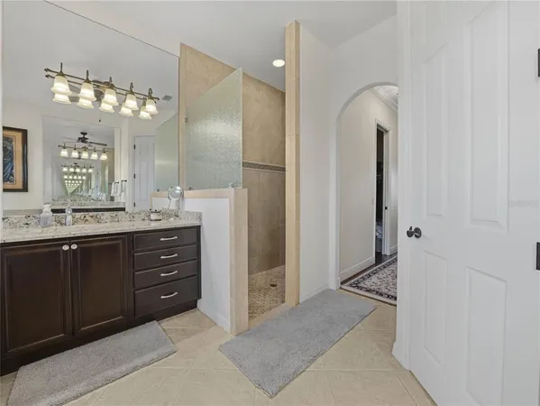 a kitchen with stainless steel appliances kitchen island granite countertop a table chairs sink and cabinets