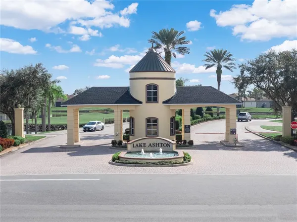 a living room with furniture kitchen view and a large window