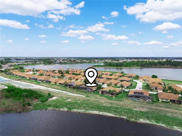 a kitchen with stainless steel appliances granite countertop wooden cabinets a sink dishwasher a stove and a refrigerator with wooden floor