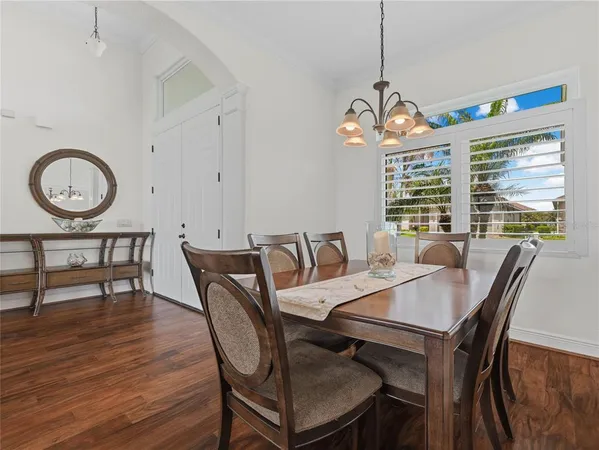 a kitchen with stainless steel appliances granite countertop a refrigerator a oven and a wooden cabinets