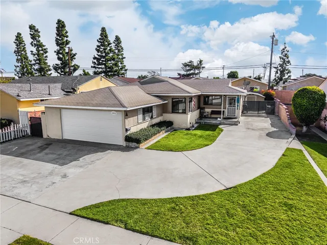 a aerial view of a house with a yard and potted plants