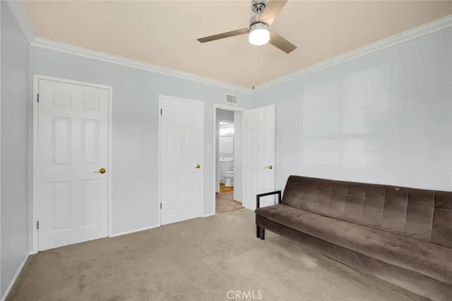 a living room with furniture and a ceiling fan