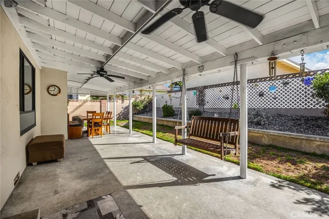 a view of a porch with furniture and a backyard