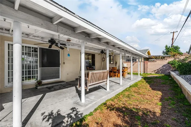 a view of a house with backyard porch and sitting area