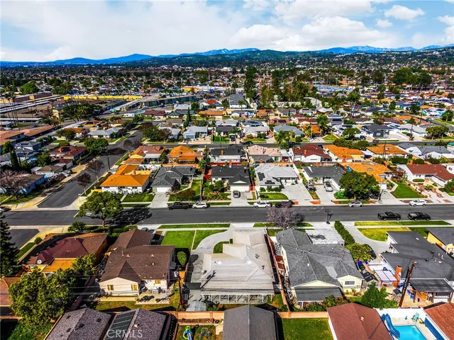 an aerial view of residential houses with outdoor space and river