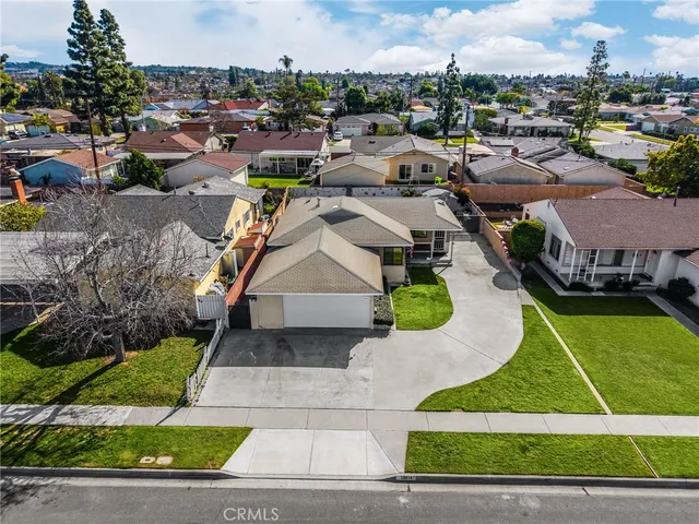 an aerial view of a house with a garden and houses