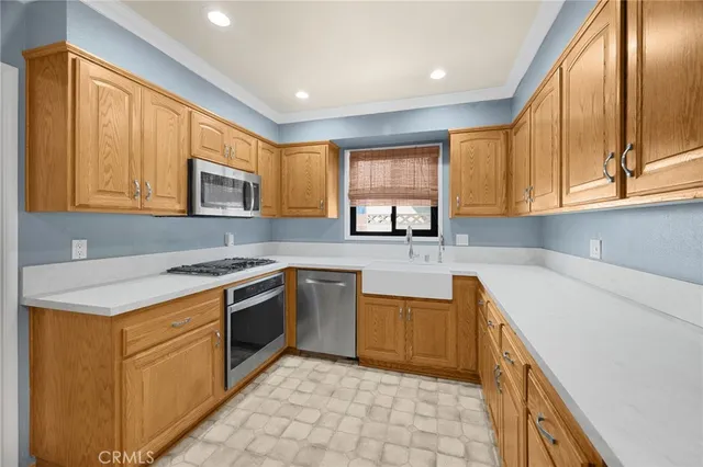 a kitchen with stainless steel appliances granite countertop a stove a sink and a microwave