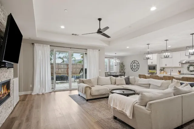a living room with furniture a flat screen tv and a fireplace