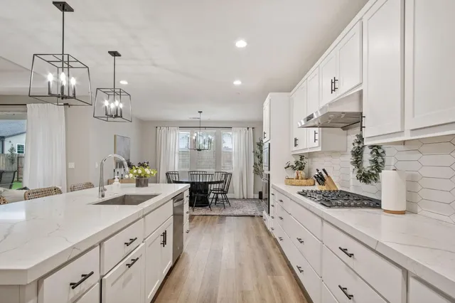 a kitchen with sink cabinets and stove