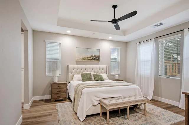 a bedroom with a bed a window and a chandelier