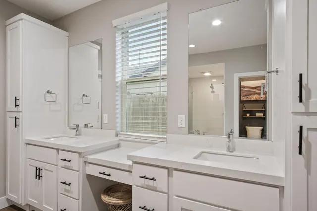 a bathroom with a sink double vanity and a mirror
