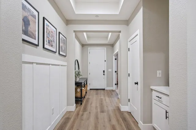 a view of a hallway with wooden floor and staircase