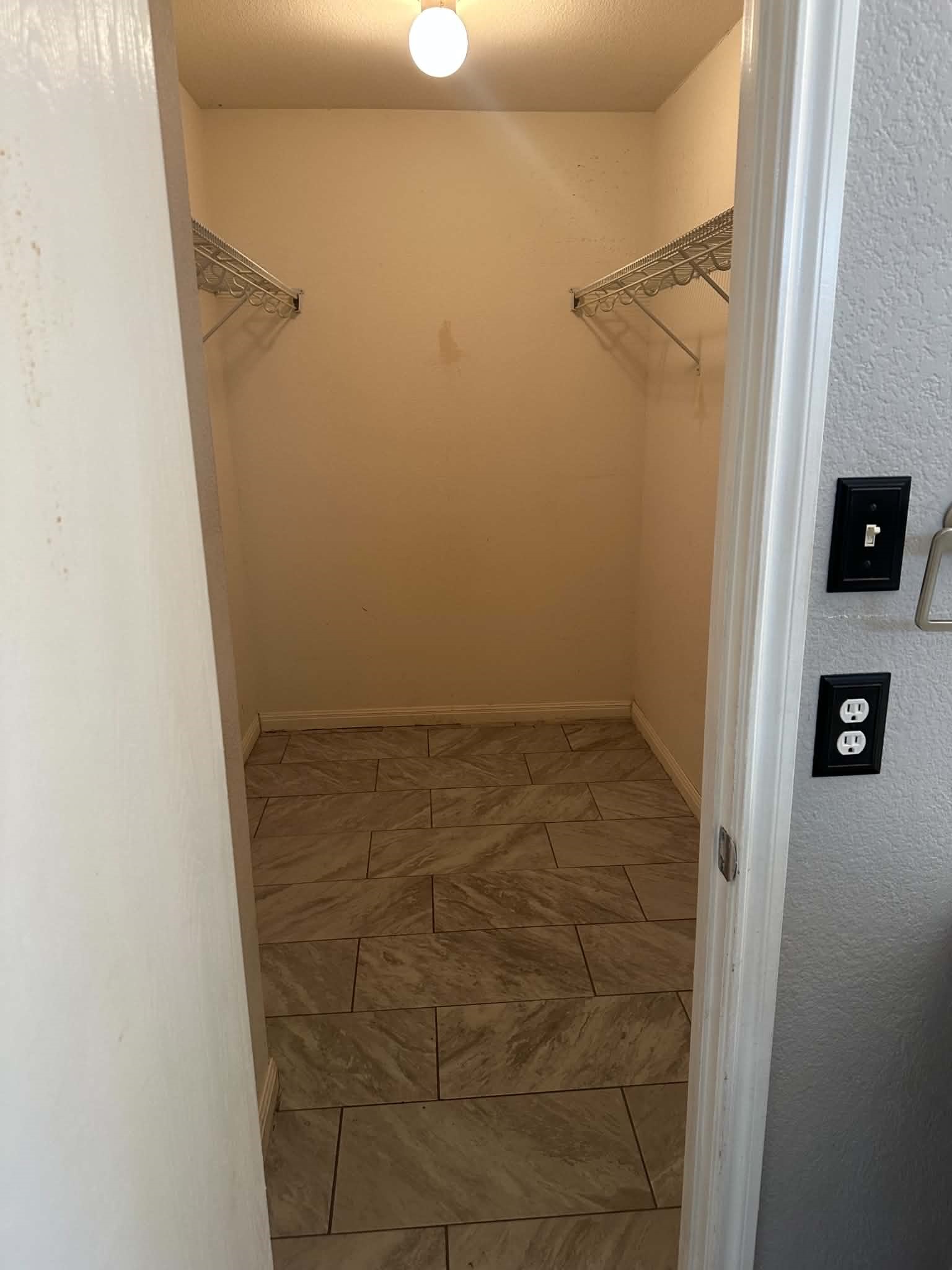 18312 Crestwind Lane Elgin, TX 78621 - Photo 10 of 15 Ample shelving and tiled floors define this functional walk-in closet.