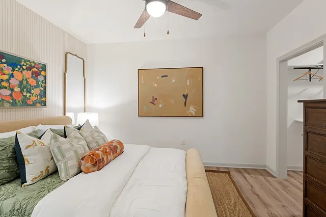 a bedroom with a bed and a painting on the wall
