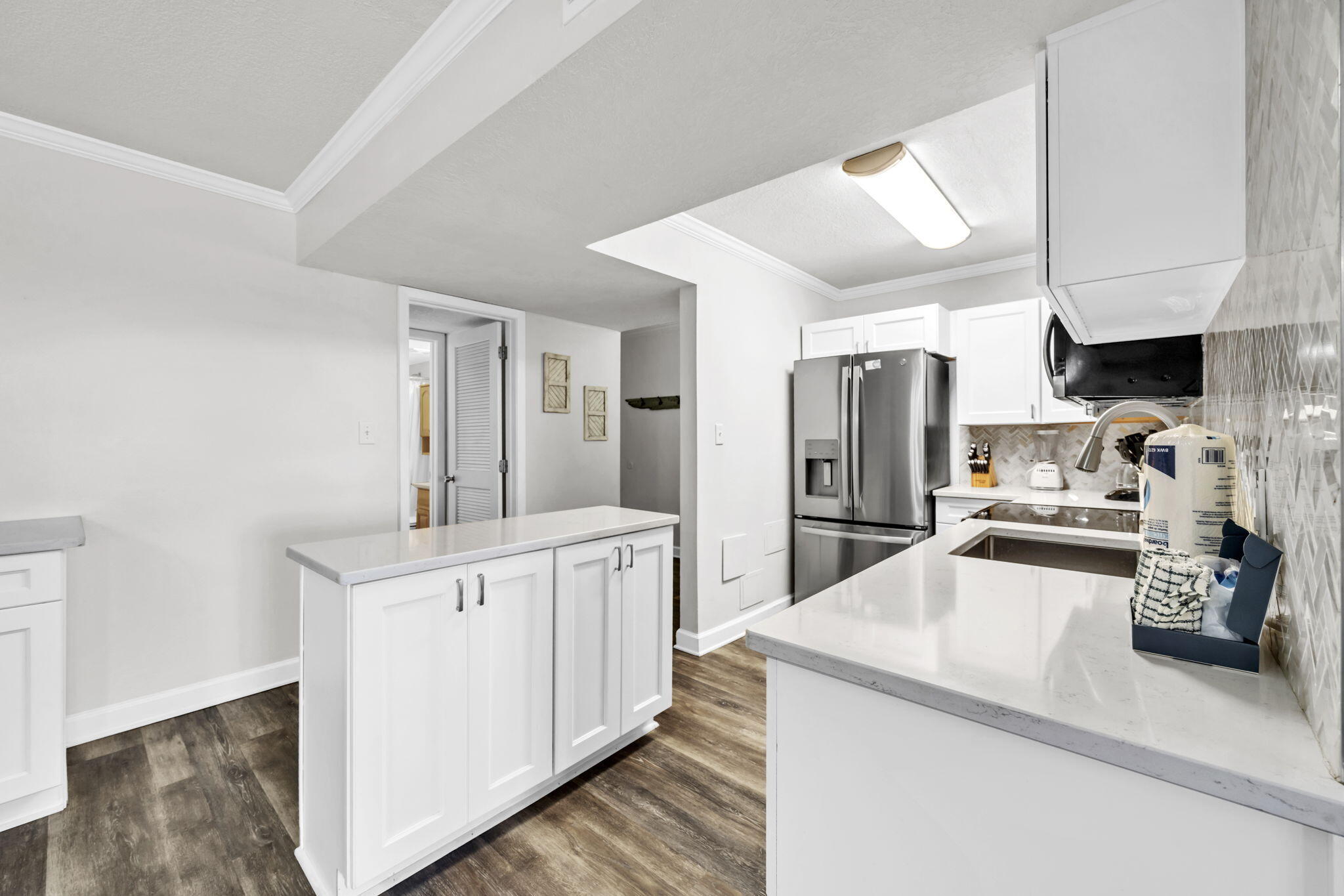 676 Santa Rosa Boulevard, Unit 1F Fort Walton Beach, FL 32548 - Photo 11 of 36 a kitchen with stainless steel appliances a sink a stove a refrigerator cabinets and a window