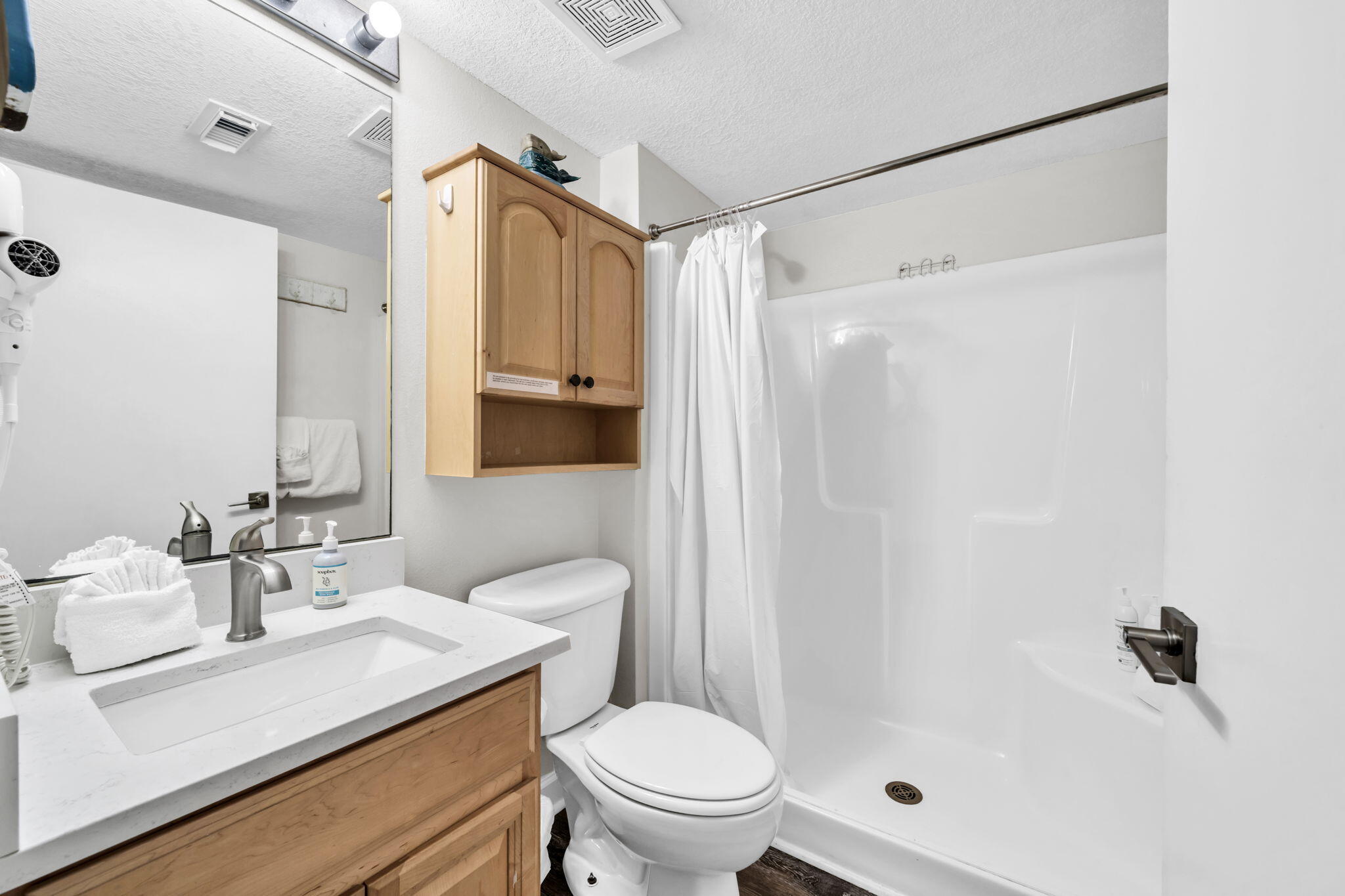 676 Santa Rosa Boulevard, Unit 1F Fort Walton Beach, FL 32548 - Photo 20 of 36 a bathroom with a sink a toilet and shower