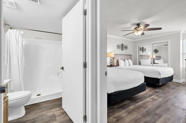 a bedroom with a large bed and a chandelier