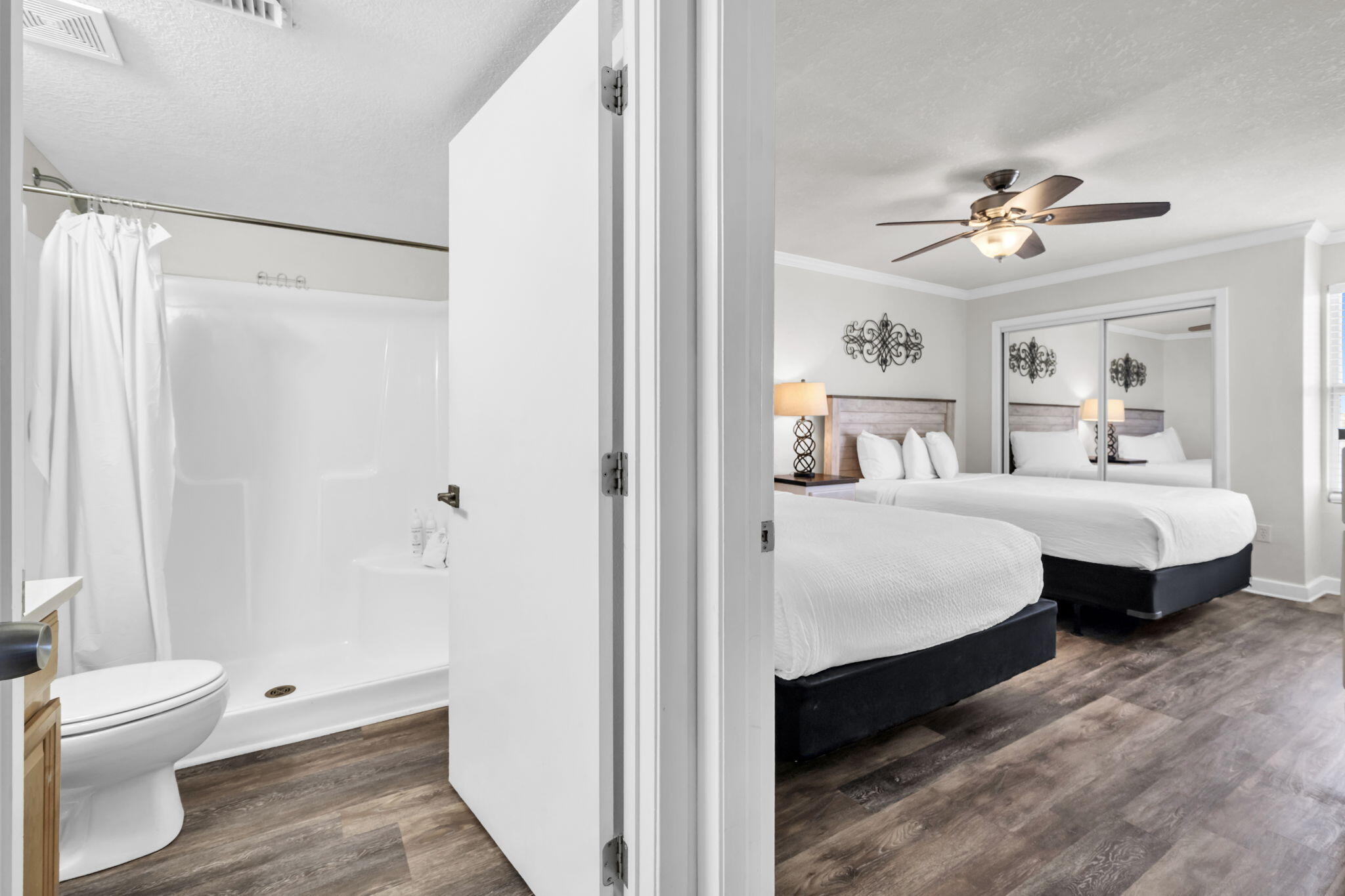 676 Santa Rosa Boulevard, Unit 1F Fort Walton Beach, FL 32548 - Photo 21 of 36 a bedroom with a bed and a chandelier