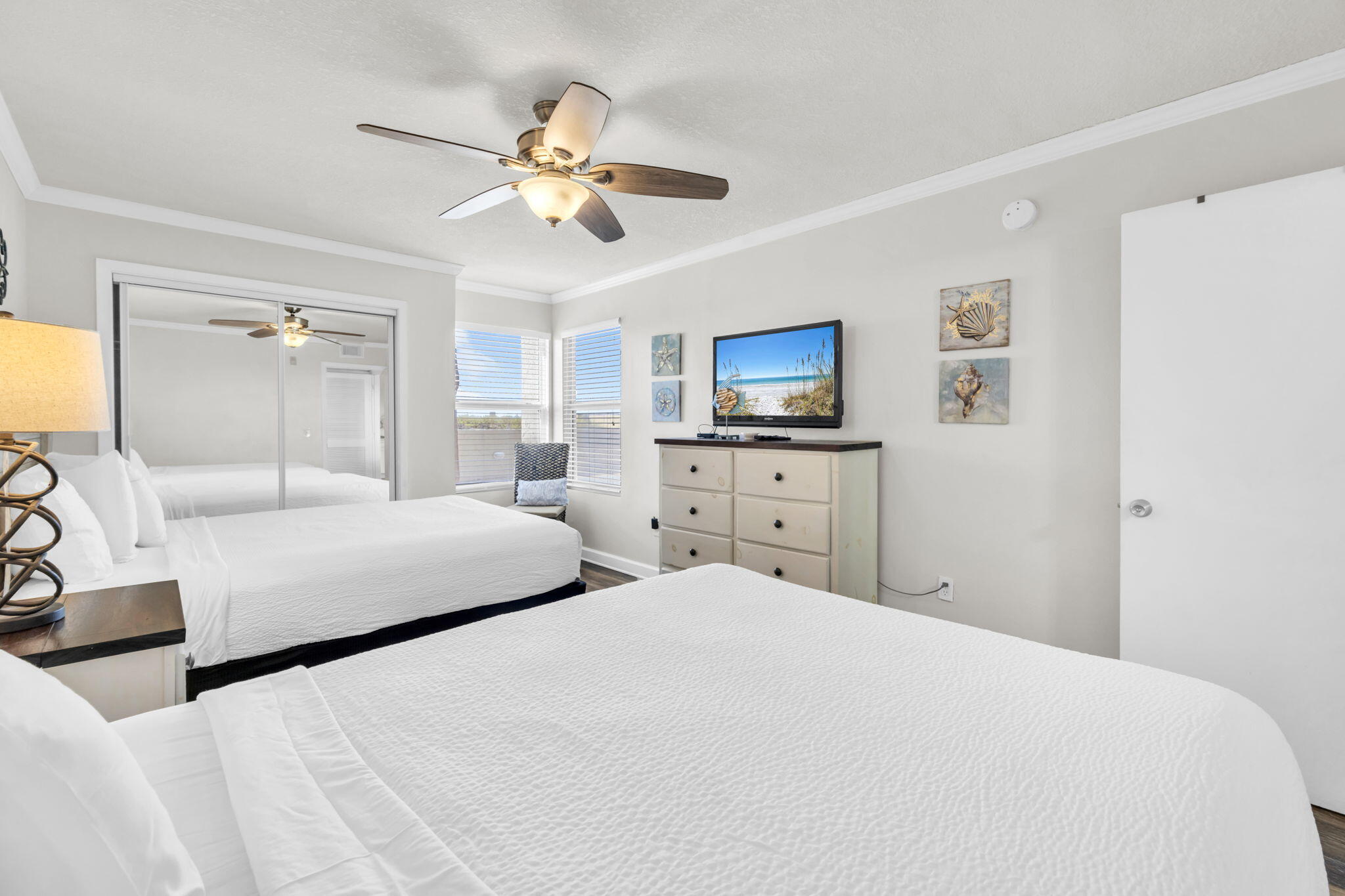 676 Santa Rosa Boulevard, Unit 1F Fort Walton Beach, FL 32548 - Photo 23 of 36 a bedroom with a bed and a chandelier