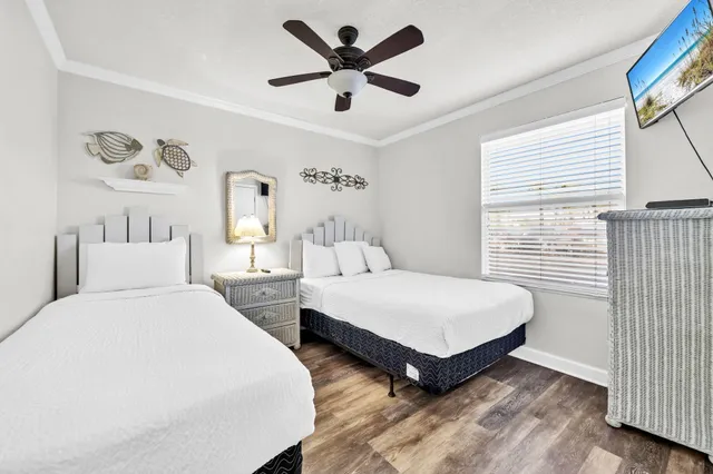 a spacious bedroom with two beds and a large window