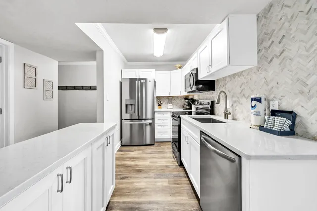 a kitchen with cabinets and stainless steel appliances