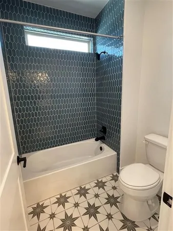a bathroom with a toilet and a bathtub