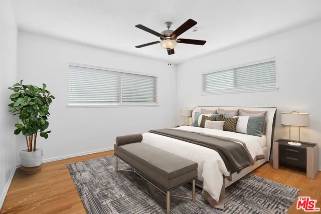 a bedroom with a bed and a potted plant