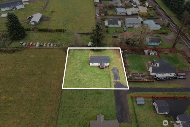 an aerial view of a house with a yard