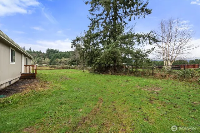 a backyard of a house with lots of green space and garden