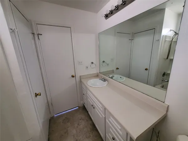a bathroom with a sink a mirror and a shower