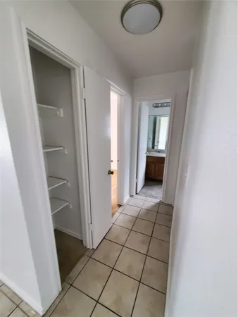 a view of empty room with wooden floor and cabinet