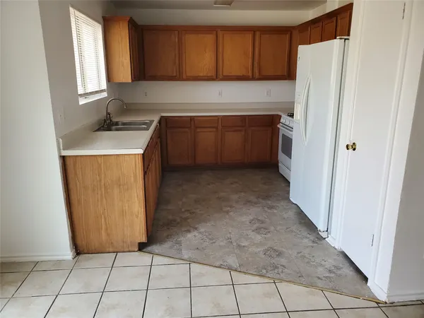 a kitchen with stainless steel appliances a sink and a refrigerator