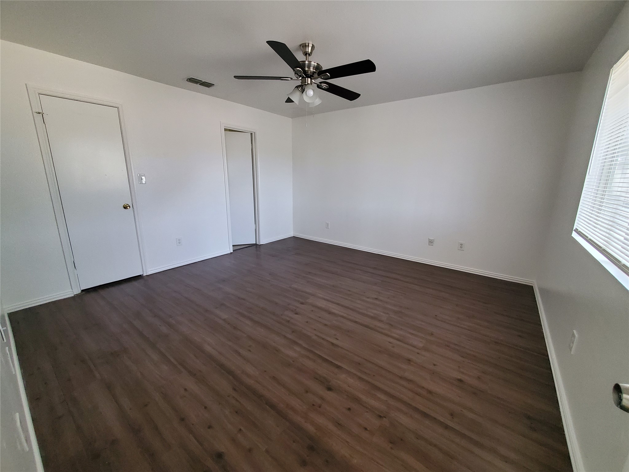 7209 Ritchie Drive Austin, TX 78724 - Photo 10 of 33 an empty room with wooden floor and ceiling fan