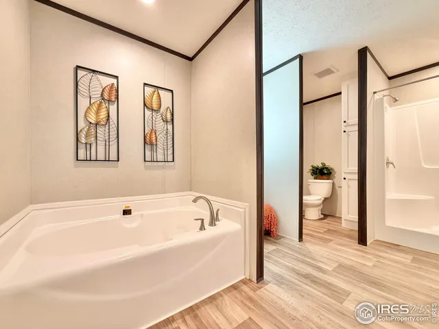 a white bath tub sitting next to a bathroom
