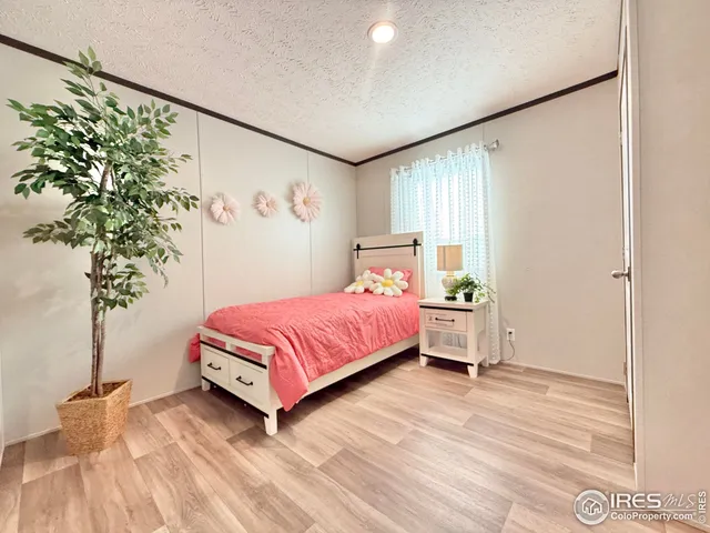 a bedroom with a bed and a potted plant