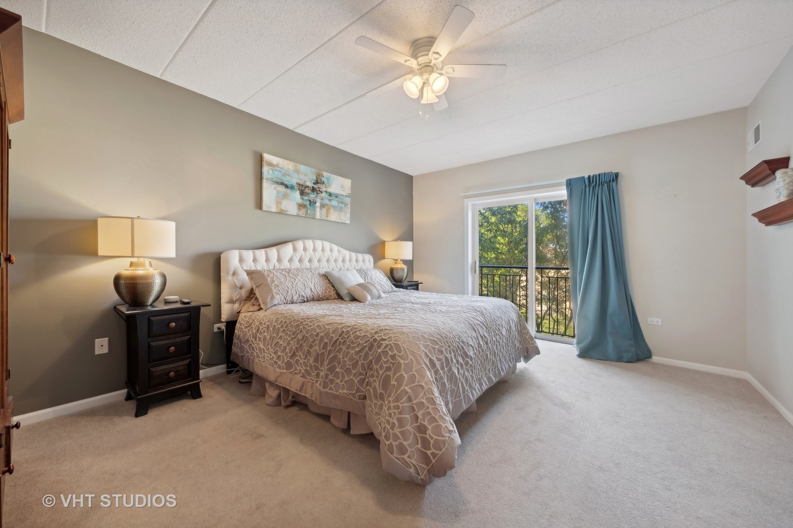 111 North Wheaton Avenue, Unit 306 Wheaton, IL 60187 - Photo 12 of 16 a spacious bedroom with a large bed and a chandelier