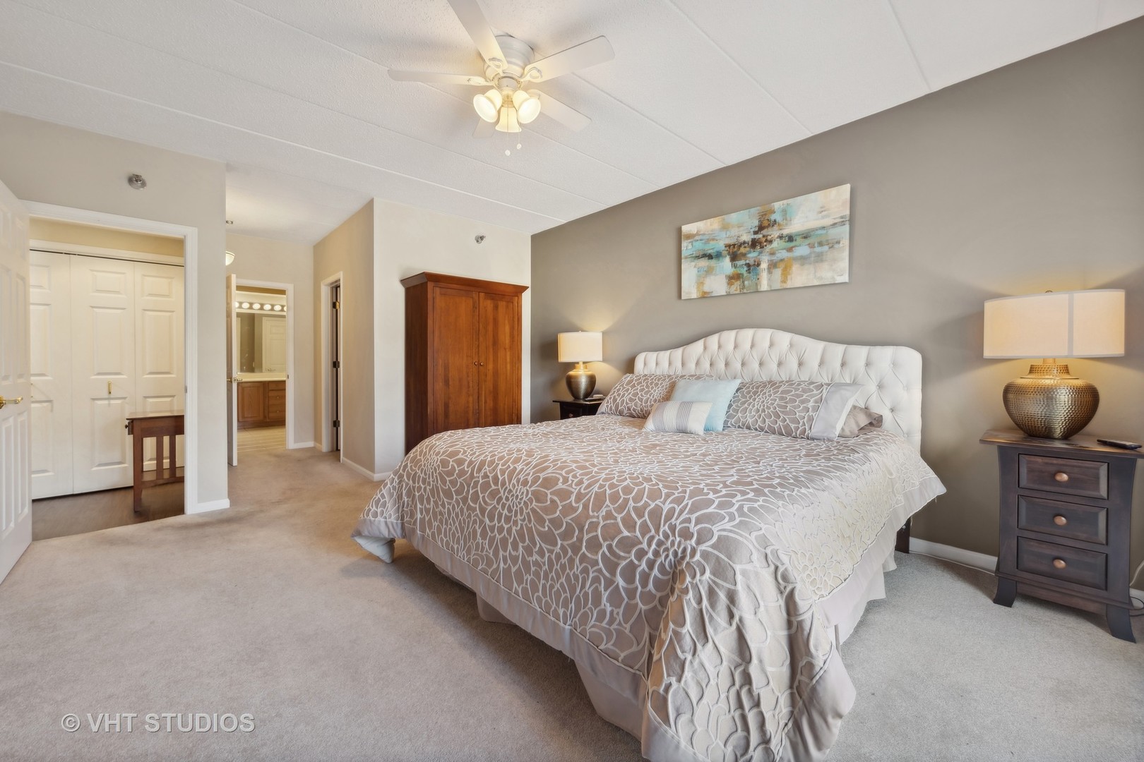 111 North Wheaton Avenue, Unit 306 Wheaton, IL 60187 - Photo 13 of 16 a bedroom with a bed and a chandelier