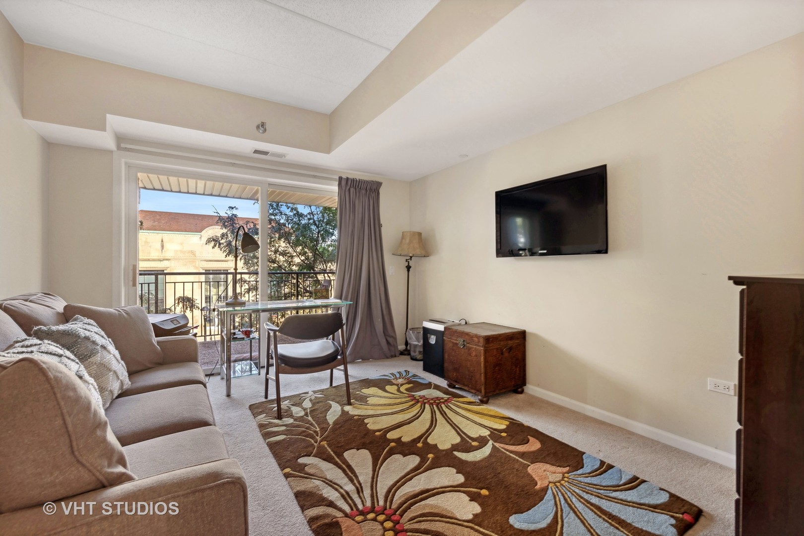 111 North Wheaton Avenue, Unit 306 Wheaton, IL 60187 - Photo 15 of 16 a living room with furniture and a flat screen tv