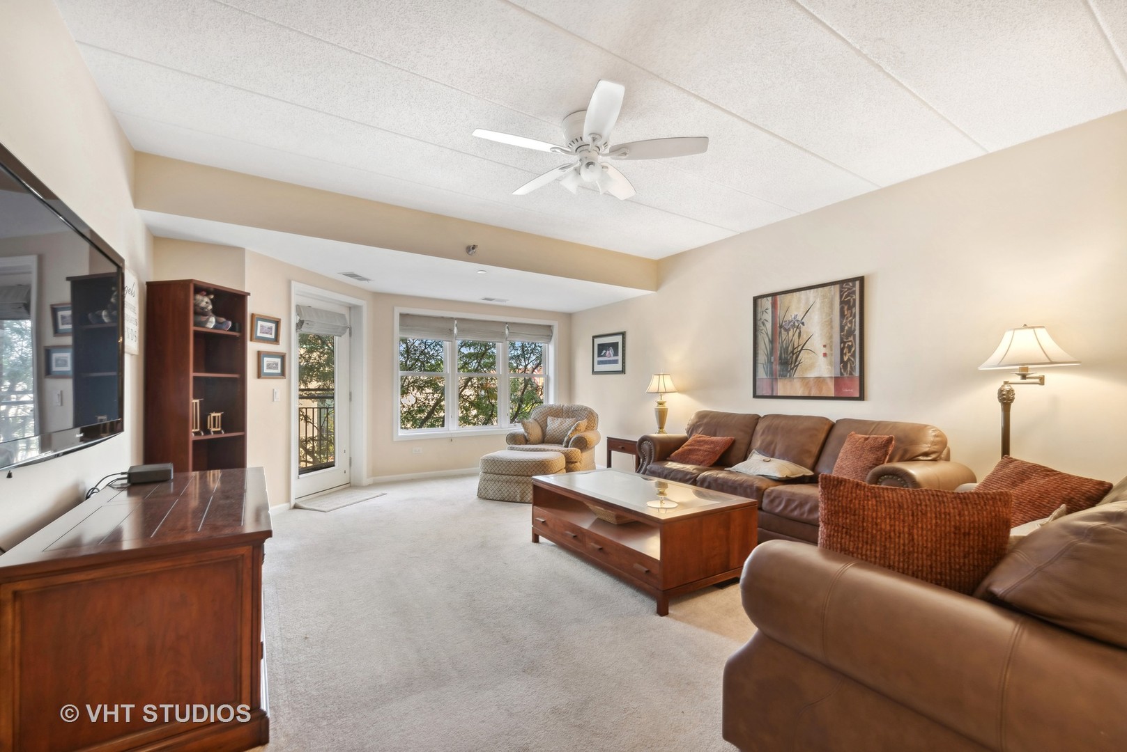 111 North Wheaton Avenue, Unit 306 Wheaton, IL 60187 - Photo 4 of 16 a living room with furniture and a large window