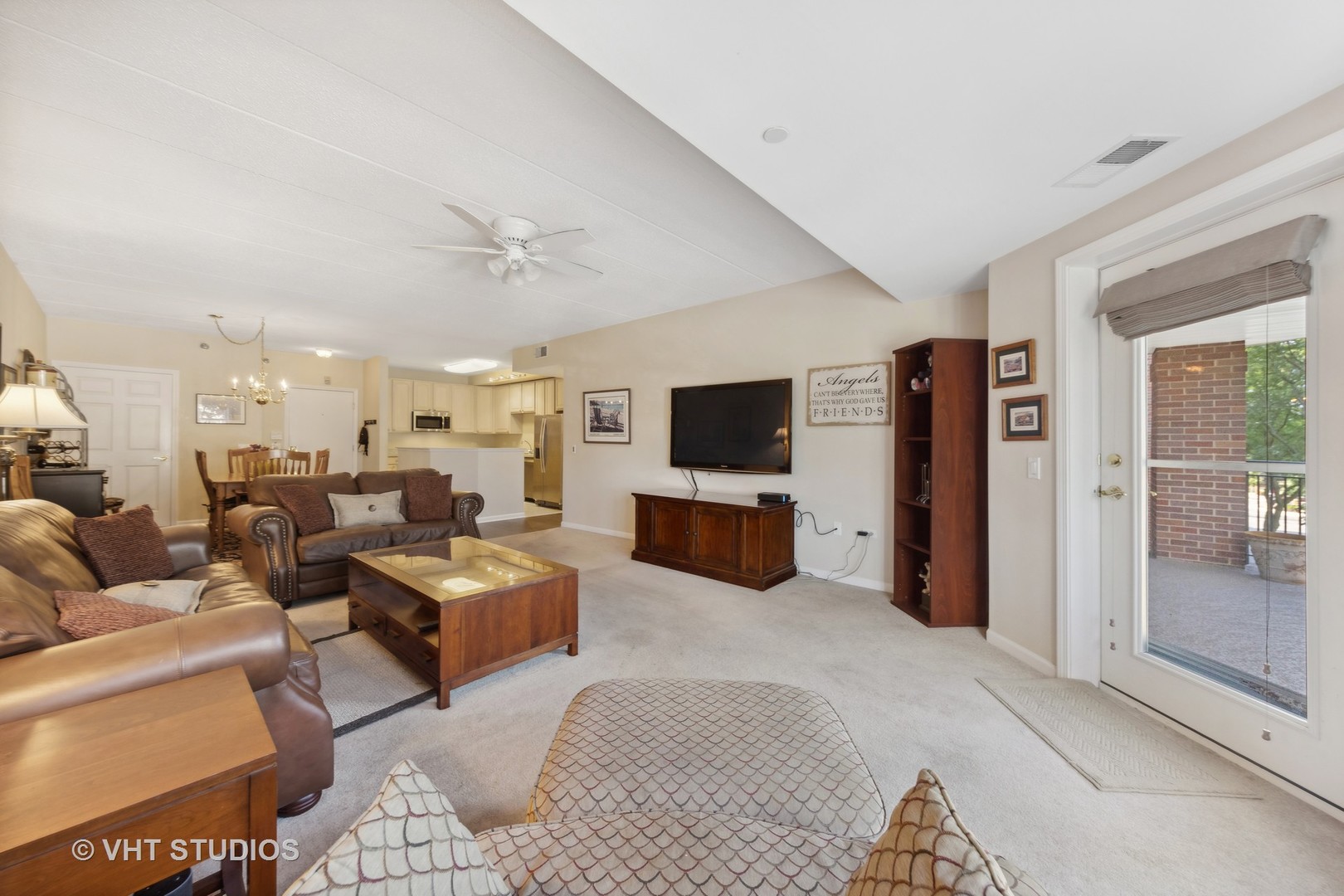 111 North Wheaton Avenue, Unit 306 Wheaton, IL 60187 - Photo 5 of 16 a living room with furniture and a flat screen tv