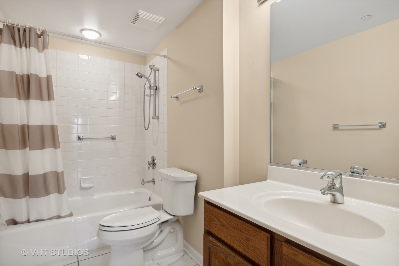 111 North Wheaton Avenue, Unit 306 Wheaton, IL 60187 - Photo 10 of 16 a bathroom with a sink toilet vanity and shower