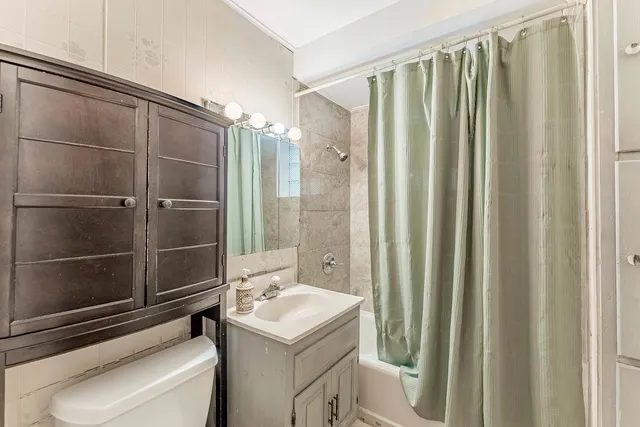 a bathroom with a shower and a sink