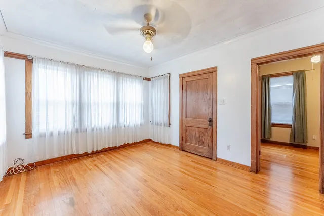 wooden floor in an empty room with a window
