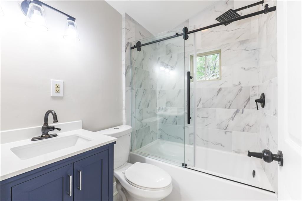1767 Line Street Decatur, GA 30032 - Photo 18 of 26 a bathroom with a shower sink vanity mirror and toilet