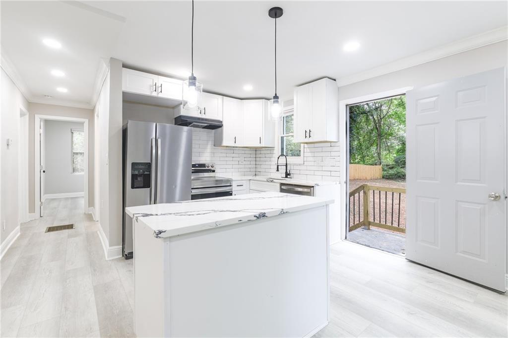 1767 Line Street Decatur, GA 30032 - Photo 8 of 26 a kitchen with kitchen island a sink stove and refrigerator