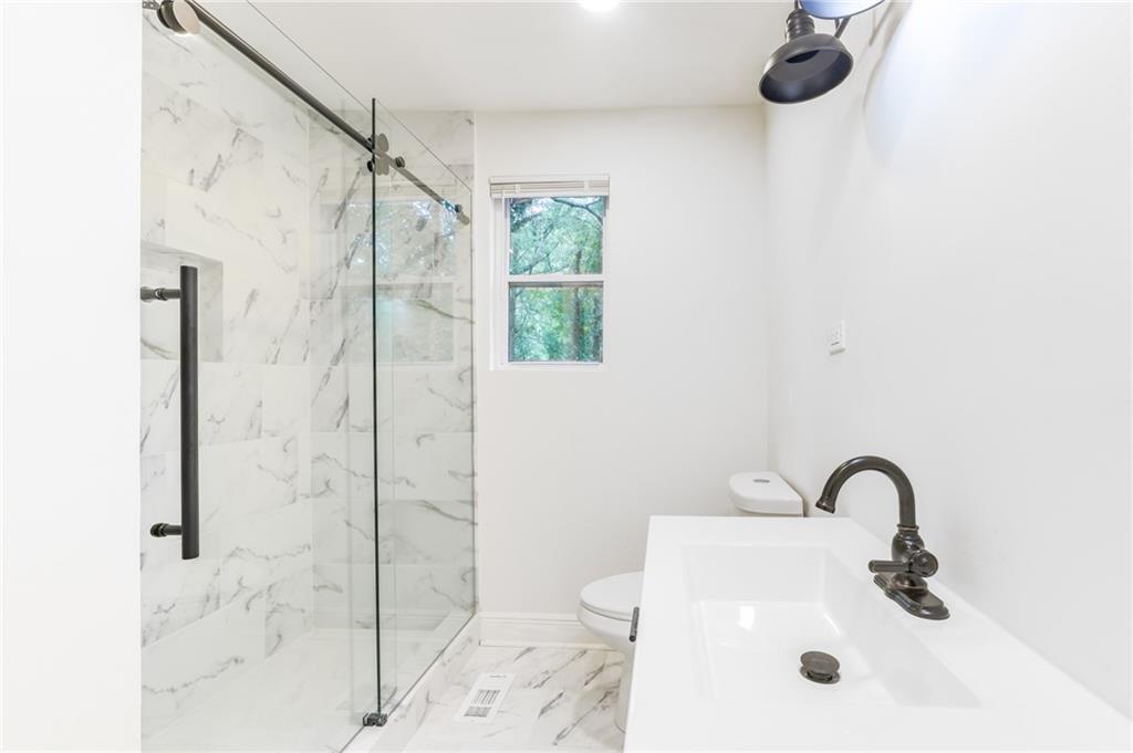 1767 Line Street Decatur, GA 30032 - Photo 9 of 26 a bathroom with a sink a shower and a mirror