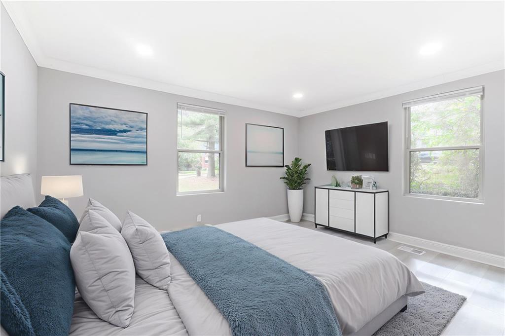 1767 Line Street Decatur, GA 30032 - Photo 10 of 26 a bedroom with a large bed and a flat tv screen