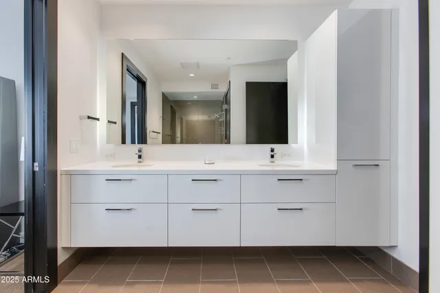 a bathroom with a sink vanity and mirror